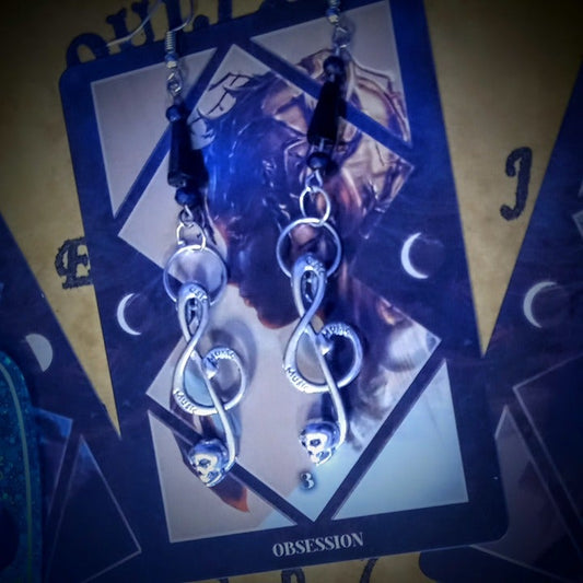 Handcrafted skull G-clef kinetic music earrings