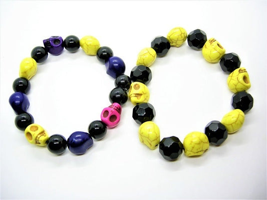 Stack of 3 skull bracelets with black glass beads and dyed howlite